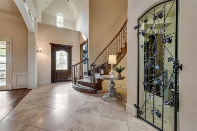 As you enter, the curved wrought iron stairway add