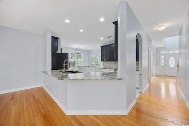 Kitchen featuring refrigerator, light wood-type fl