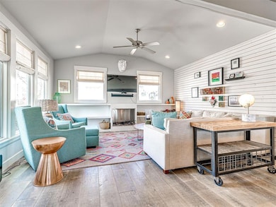 Living area featuring recessed lighting, vaulted c