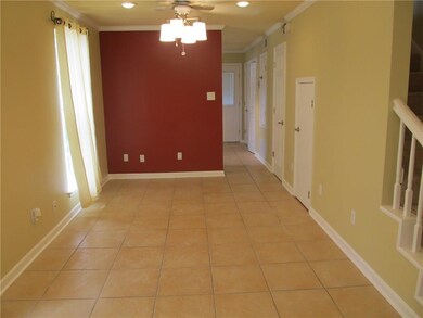 Freshly painted den with ceiling fan and recessed