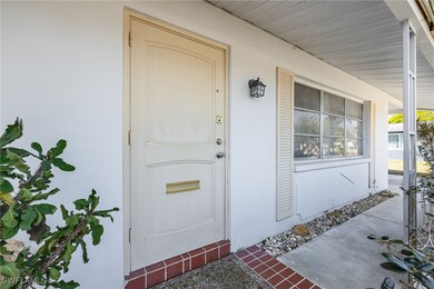 Doorway to property featuring covered porch