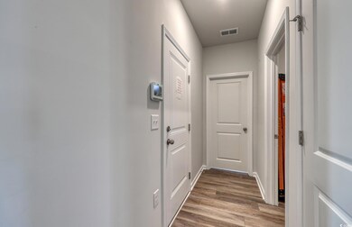 Hall featuring dark wood-type flooring, baseboards