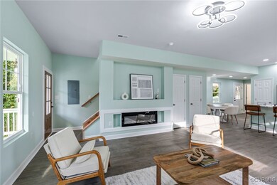 Living room featuring electric panel and dark wood