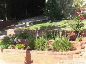 Walkway flanked by beautiful brick planters