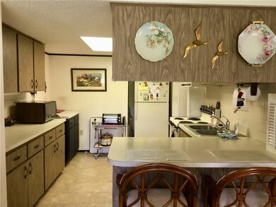 Kitchen has a flow through plan and a breakfast ba