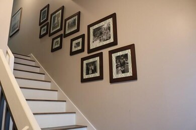 Entrance way with pretty stairs and new wood floor
