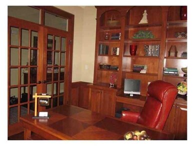 Den. Library with built-in bookcases, stained half