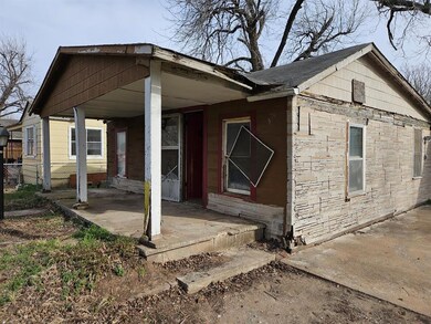 Rear view of property featuring fence