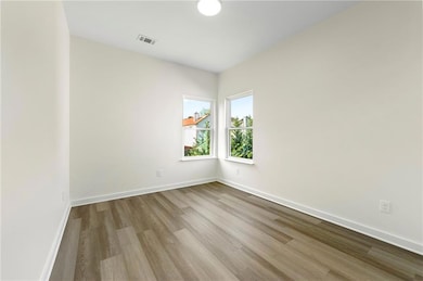 Unfurnished room featuring light wood-type flooring and baseboards