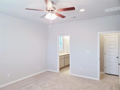 Unfurnished bedroom with light colored carpet, re