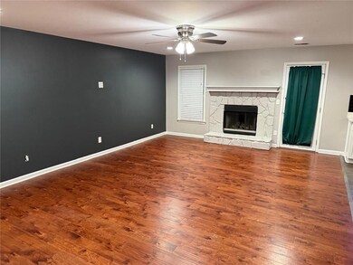 Unfurnished living room with ceiling fan, wood finished floors, a fireplace, and recessed lighting
