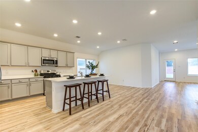 Kitchen with stainless steel appliances, gray cab