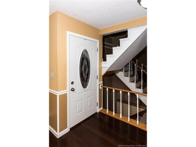 THE FRONT ENTRY HAS A DECORATIVE GLASS DOOR.