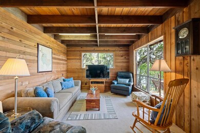 Living room featuring a wood ceiling with exposed