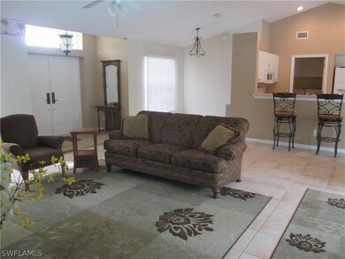 Living room, front entry, formal dining (far left), breakfast bar and kitchen (far right)