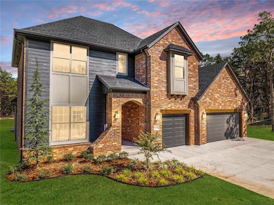 Traditional home featuring concrete driveway, roof with shingles, brick siding, and a yard