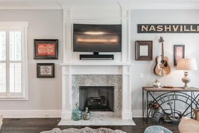 Cozy fireplace with gas logs! Notice the rich hardwood floors.