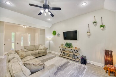 Family Room with new recessed lighting, ceiling fan, flooring, and paint.