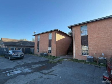 View of side of home featuring brick siding and stairs