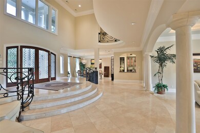 The open floor plan provides an impressive space for entertainment in the formal living room and dining room with a wet bar in the distance conveniently located between the formal areas and the kitchen. The sound system located throughout the living areas and back yard add to the ambiance of this amazing home.