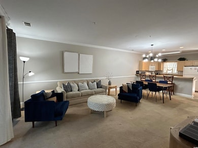Living room featuring a chandelier, light carpet, 
