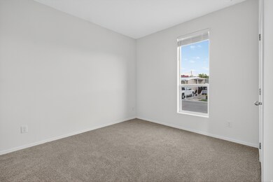 Carpeted empty room with baseboards