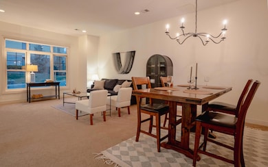 Great room with an open layout, freshly painted walls, and a large window that fills the space with natural light — perfect for relaxing or entertaining.
