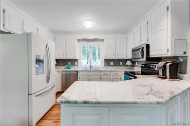 Kitchen with hardwood flooring, natural light, sta