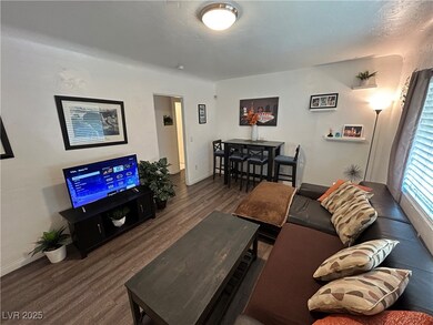 Living room featuring wood finished floors and bas