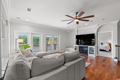 Living room with hardwood / wood-style floors, a f