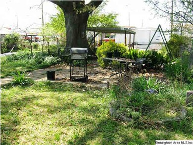 Lush backyard with shaded patio perfect for grilli