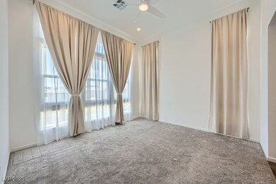Carpeted spare room with a ceiling fan and baseboa
