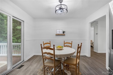 Dining area with wood finished floors and baseboar