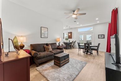 The living area is adjacent to the dining and kitc