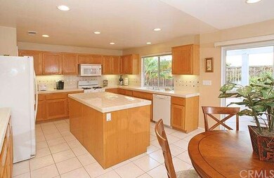 The kitchen with center island opens directly into