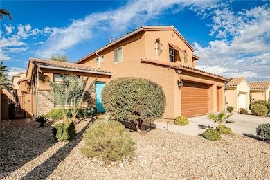 Mediterranean / spanish home with stucco siding, a tile roof, driveway, and stone siding