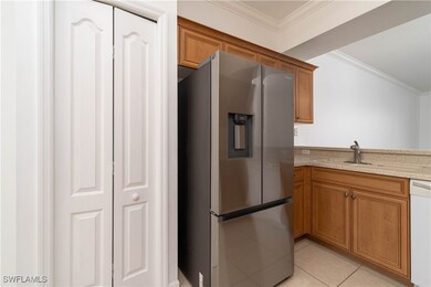 Kitchen with crown molding, white dishwasher, a si