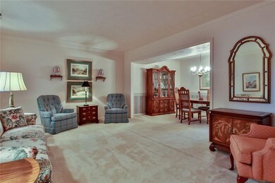 Flowing from the entry, the spacious living room o