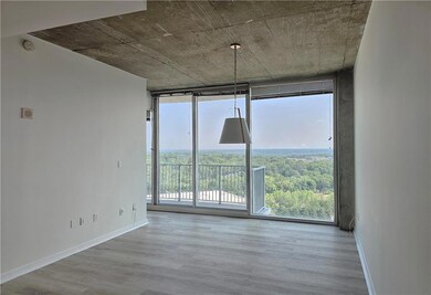Spare room with floor to ceiling windows, wood finished floors, a smoke detector, and baseboards