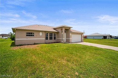 Ranch-style house with stucco siding, a garage, co