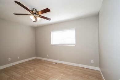 Unfurnished room featuring light wood finished floors and a ceiling fan
