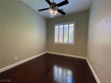 Empty room with baseboards, dark wood finished flo