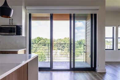 The gourmet kitchen showcases sleek white cabinetry and elegant quartz countertops with waterfall detailing.