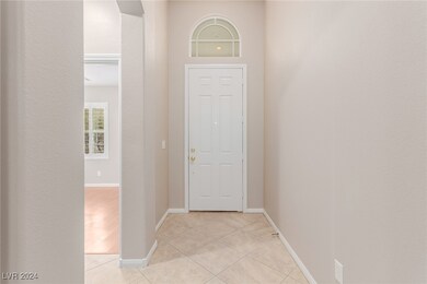 Foyer entrance with light tile patterned floors an