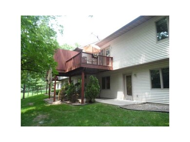 Exterior Back. Deck and walkout patio with additio