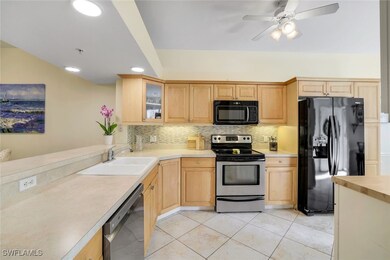 Kitchen featuring a sink, light brown cabinetry, b