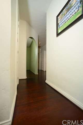 Entry hallway with refinished hardwood floors thro