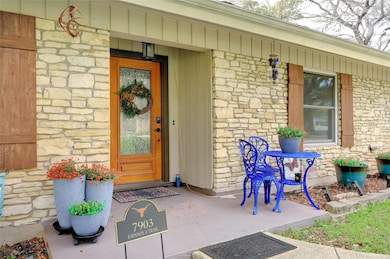 Doorway to property with stone siding