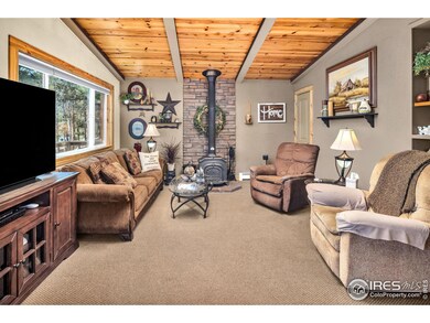 Cozy living space with vaulted tongue & groove beamed ceilings complete with a wood burning stove and stunning new stonework