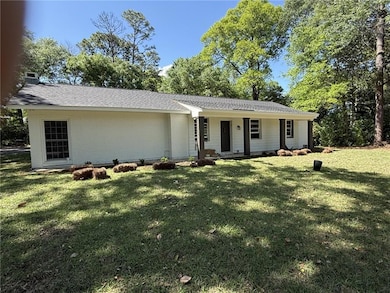 View of front facade with brick siding, roof with 